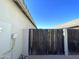 View of the side yard gate leading to a paved area with block wall, and a nice blue sky above at 18427 E Verde Ct, Gold Canyon, AZ 85118