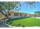 Spacious backyard featuring artificial grass, covered patio and pergola at 19808 N 3Rd Ave, Phoenix, AZ 85027