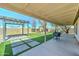 Inviting backyard featuring synthetic grass, a covered patio, and pergola at 19808 N 3Rd Ave, Phoenix, AZ 85027