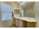 Bright bathroom with tile floors, a white vanity, and a large mirror at 19808 N 3Rd Ave, Phoenix, AZ 85027