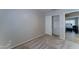 Bedroom with a sliding door closet, neutral carpet, and view into the next room at 19808 N 3Rd Ave, Phoenix, AZ 85027