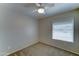 Bedroom featuring neutral carpet, a ceiling fan, and a bright window with blinds at 19808 N 3Rd Ave, Phoenix, AZ 85027
