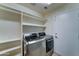 Laundry room featuring modern appliances, shelving and a white door at 19808 N 3Rd Ave, Phoenix, AZ 85027