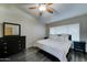 Comfortable primary bedroom with a ceiling fan and dark wood look flooring at 19808 N 3Rd Ave, Phoenix, AZ 85027