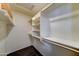 Walk-in closet providing ample storage and organization with high ceilings and custom shelving at 19808 N 3Rd Ave, Phoenix, AZ 85027
