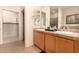Bathroom featuring double sinks with a walk-in closet and a separate shower at 20750 N 87Th St # 1065, Scottsdale, AZ 85255