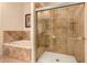 Bathroom with a shower and bathtub with tile surround and glass doors at 20750 N 87Th St # 1065, Scottsdale, AZ 85255