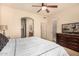 Bright bedroom featuring a ceiling fan, an ensuite bathroom and a large dresser at 20750 N 87Th St # 1065, Scottsdale, AZ 85255