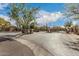 Gated community entrance featuring lush landscaping, stone signage, and controlled access at 20750 N 87Th St # 1065, Scottsdale, AZ 85255