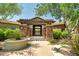 Stone structure marks the entrance to a lovely community with lush landscaping at 20750 N 87Th St # 1065, Scottsdale, AZ 85255