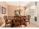 Inviting dining room features decorative chairs, chandelier, and a window with shutters at 20750 N 87Th St # 1065, Scottsdale, AZ 85255