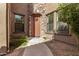 Charming front entrance with stone accents, a welcoming wreath, and manicured landscaping at 20750 N 87Th St # 1065, Scottsdale, AZ 85255