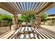 Outdoor grilling area with built-in barbeque, seating, and a stone picnic table at 20750 N 87Th St # 1065, Scottsdale, AZ 85255