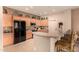 Well-lit kitchen features a breakfast bar, black appliances, and light wood cabinets at 20750 N 87Th St # 1065, Scottsdale, AZ 85255