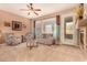 Bright living room with a ceiling fan, fireplace, and access to the outdoor patio at 20750 N 87Th St # 1065, Scottsdale, AZ 85255