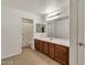 Bathroom with a full vanity, and full bath with a patterned shower curtain at 21759 E Estrella Rd, Queen Creek, AZ 85142