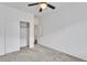 A modern bedroom with neutral carpet, ceiling fan, and closet with sliding doors at 21759 E Estrella Rd, Queen Creek, AZ 85142
