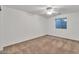 Bedroom featuring carpeted floors, a ceiling fan and natural light at 21759 E Estrella Rd, Queen Creek, AZ 85142