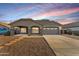 Charming single-story home with a well-manicured front yard and a covered entrance and a two car garage at 21759 E Estrella Rd, Queen Creek, AZ 85142