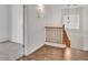 Bright hallway with hardwood floors and a view of the stairs and a chandelier at 21759 E Estrella Rd, Queen Creek, AZ 85142