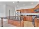 Modern kitchen with stainless appliances, tile floors, a large island and abundant cabinet space at 21759 E Estrella Rd, Queen Creek, AZ 85142