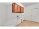 Laundry room featuring tile floors and built-in storage above the washer and dryer hookups at 21759 E Estrella Rd, Queen Creek, AZ 85142