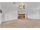 Open-concept living room with plush carpet and partial view of the adjoining kitchen at 21759 E Estrella Rd, Queen Creek, AZ 85142