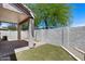 Private back patio with pavers, partial artificial turf, stucco wall, shade cover and satellite dish at 22225 N 29Th Dr, Phoenix, AZ 85027