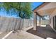 Private back patio featuring pavers, a stucco wall, shade cover, and a mature desert tree in the background at 22225 N 29Th Dr, Phoenix, AZ 85027