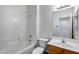 Bright bathroom with tub and shower combo with oak vanity and neutral colored wall paint at 22225 N 29Th Dr, Phoenix, AZ 85027