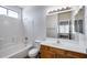 Bright bathroom with tub and shower combo with oak vanity and neutral colored wall paint at 22225 N 29Th Dr, Phoenix, AZ 85027