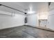 Spacious garage features concrete floor, a water heater, and an interior white door at 22225 N 29Th Dr, Phoenix, AZ 85027