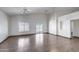 Open-concept living room with tile flooring, neutral walls, and sliding glass door to patio at 22225 N 29Th Dr, Phoenix, AZ 85027