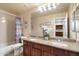 Bathroom with double sinks, granite countertops, wood cabinets, shower-tub combo and neutral walls at 22233 N 54Th Way, Phoenix, AZ 85054
