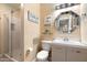 Bright bathroom with updated vanity, framed mirror, and glass enclosed shower at 22233 N 54Th Way, Phoenix, AZ 85054