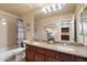 Bathroom featuring double sinks, granite countertops, and a shower-tub combination at 22233 N 54Th Way, Phoenix, AZ 85054