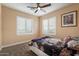 Comfortable bedroom with a bed, carpet flooring, and plantation shutters at 22233 N 54Th Way, Phoenix, AZ 85054