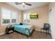 Cozy bedroom with a bed, side table, and tv mounted on the wall at 22233 N 54Th Way, Phoenix, AZ 85054