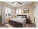 Well-lit bedroom with a large window, plush bedding, and classic furniture at 22233 N 54Th Way, Phoenix, AZ 85054