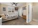 Comfortable bedroom with a ceiling fan, window with shutters, and ensuite bathroom at 22233 N 54Th Way, Phoenix, AZ 85054