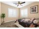 Bright bedroom features a ceiling fan, white shuttered windows, neutral walls and floral bedding at 22233 N 54Th Way, Phoenix, AZ 85054