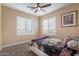 Cozy bedroom featuring a floral-themed bedspread, complemented by bright windows and neutral wall colors at 22233 N 54Th Way, Phoenix, AZ 85054