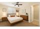 Cozy bedroom featuring neutral carpet, ceiling fan, and ensuite bathroom at 22233 N 54Th Way, Phoenix, AZ 85054