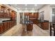 Beautiful kitchen featuring granite countertops, wood cabinetry, stainless appliances, and wood-style tile flooring at 22233 N 54Th Way, Phoenix, AZ 85054