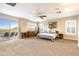 Bright, spacious main bedroom with a ceiling fan and private balcony access at 22233 N 54Th Way, Phoenix, AZ 85054