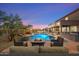 Backyard boasts a private pool, spa, grill and outdoor kitchen, and firepit area at 22233 N 54Th Way, Phoenix, AZ 85054