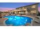 Backyard with a sparkling swimming pool, patio area, and lush desert landscaping at 22233 N 54Th Way, Phoenix, AZ 85054
