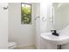 Powder bathroom featuring a pedestal sink, neutral tiling and window at 2302 S Canfield --, Mesa, AZ 85209