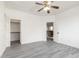 A well-lit bedroom with a ceiling fan, neutral walls, and a door that opens to a spacious closet at 2302 S Canfield --, Mesa, AZ 85209