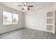 Bedroom featuring large windows, recessed wall niches, neutral paint, and gray wood-look flooring at 2302 S Canfield --, Mesa, AZ 85209